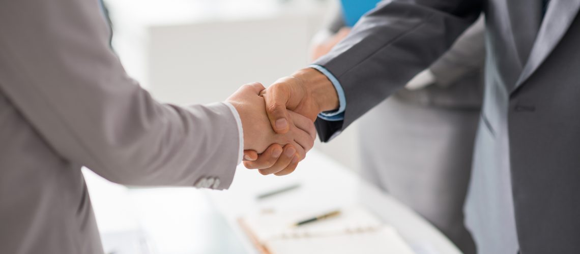 Hands of business people shaking hands after successful meeting